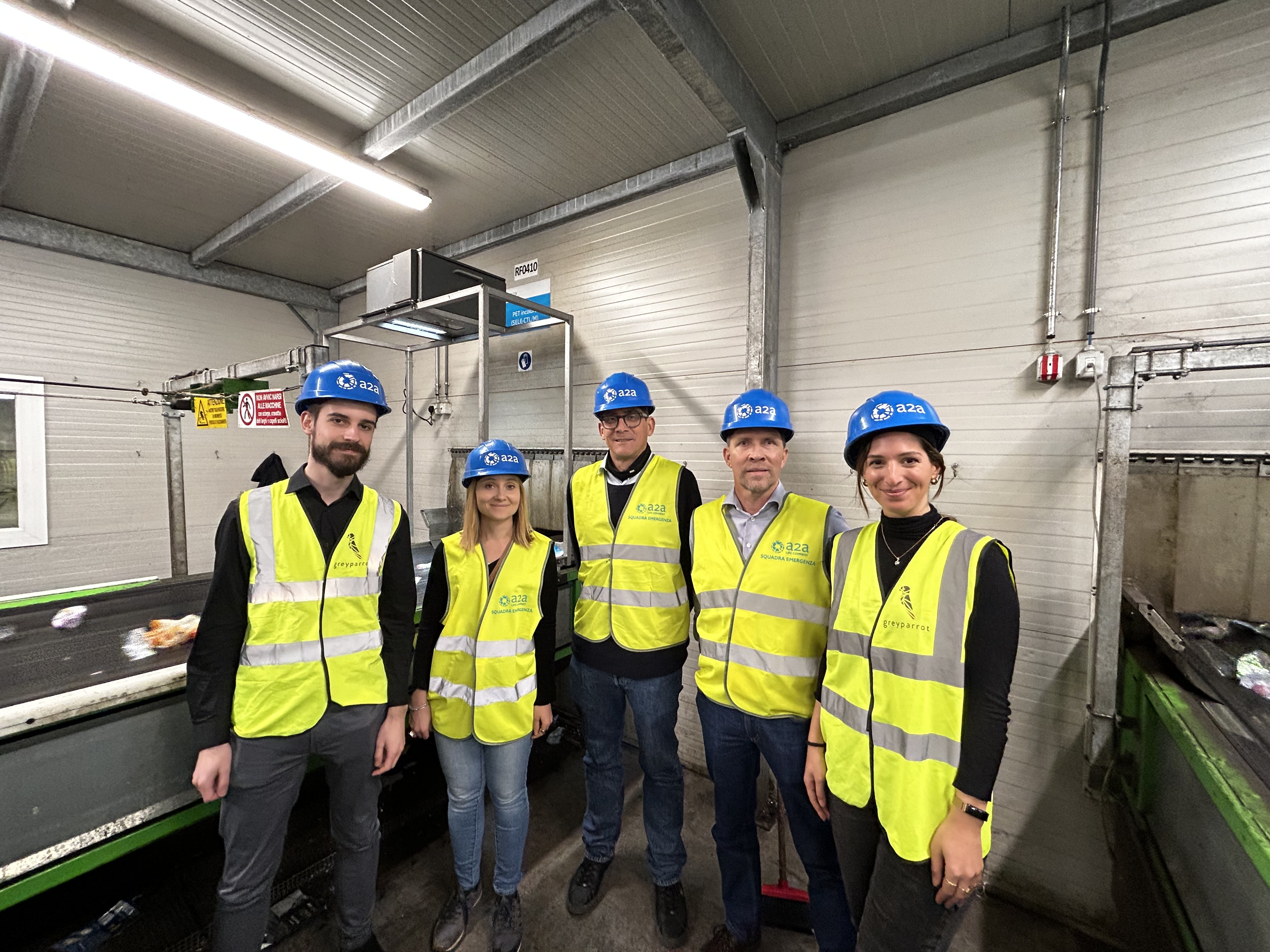 Amcor and Greyparrot representatives visit a sorting center using Greyparrot technology. 